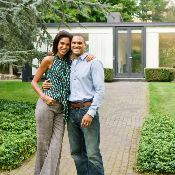 An image showing happy property owners after masonry veneer installation in Knoxville, TN.