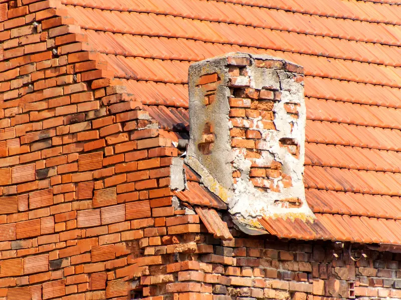 An image showing signs of masonry damage in a home, such as cracks, spalling, and staining.