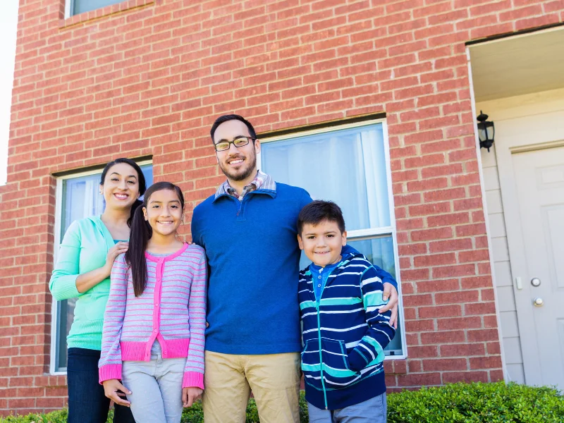 Image showing a family in front of their brick home in Knoxville.