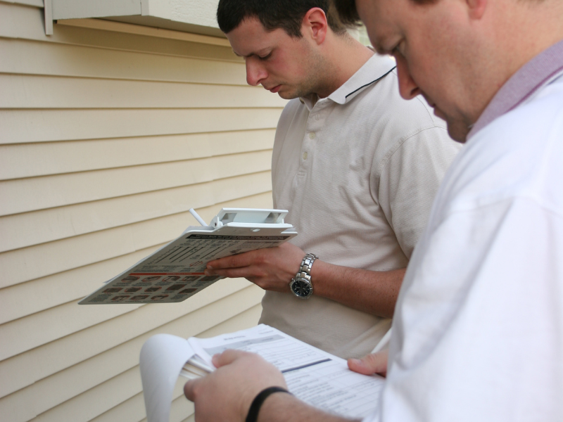 Image showing a homeowner inspecting their concrete wall.