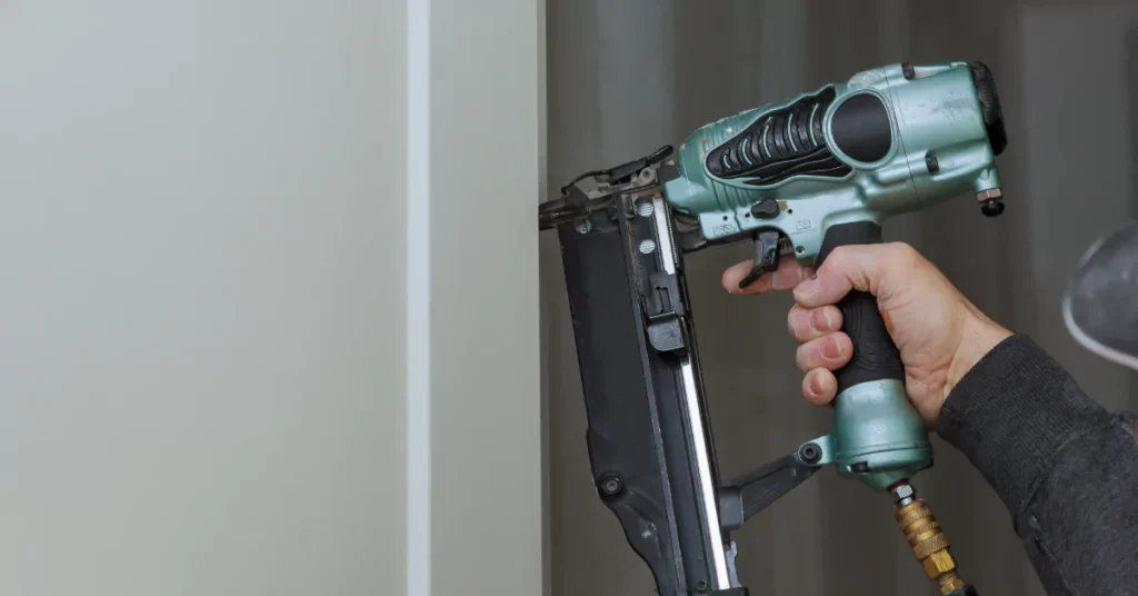 An image showing a professional using a nail gun on concrete walls in Knoxville, TN.