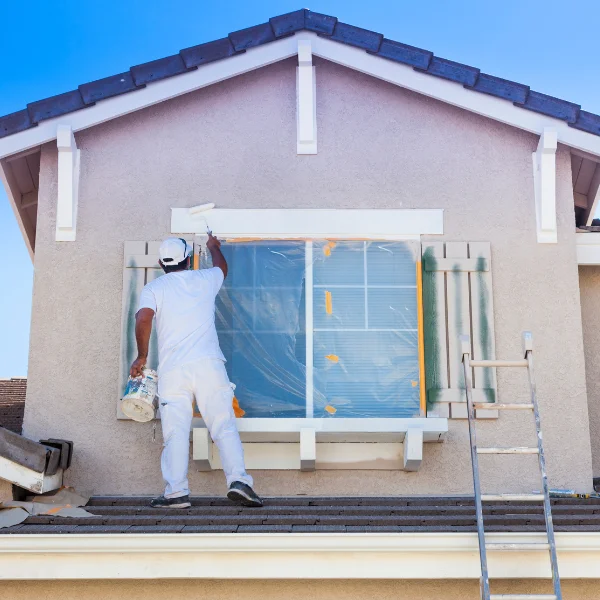 An image showing a home being painted in Knoxville for a better outdoor space.