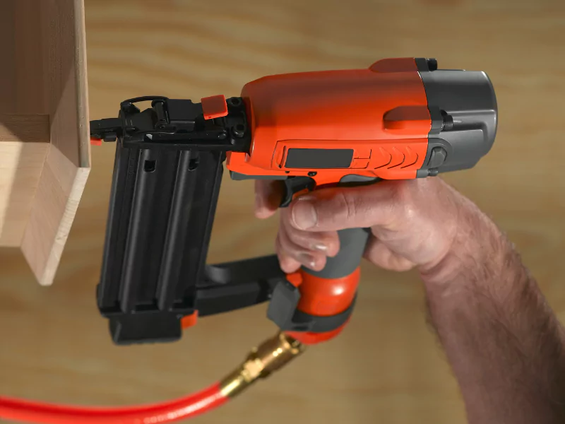 Image showing a nail gun being used on concrete walls. 